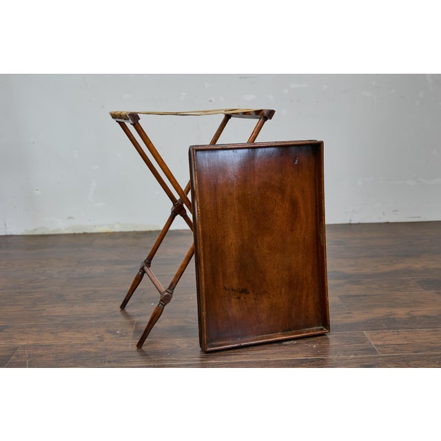 An English tray on stand mahogany side table from the 19th century. This elegant English mahogany side table from the 19th...