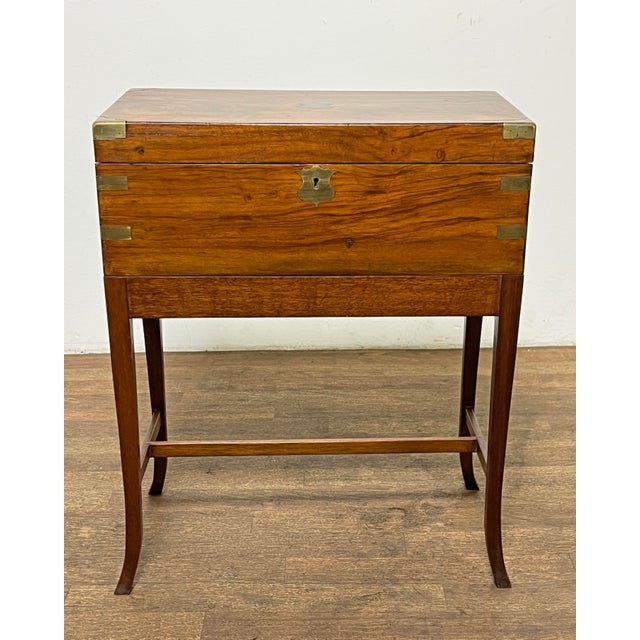 An antique officer's writing slope on stand, in Cuban mahogany with brass corner brackets circa 1850s. Measures 24.5"...