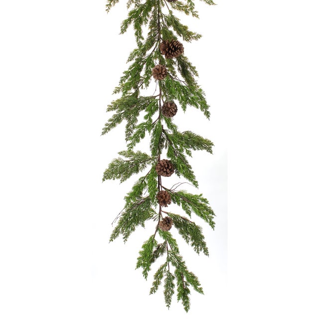 Transform your holiday home with the rustic charm of our Winter Pine Garland with Pinecone Accents. This set of two 6-foot...