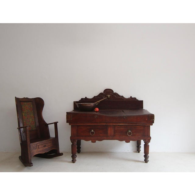 A 19th century French butcher's block in original oxblood-coloured finish. Rectangular beechwood body standing on 4 feet...
