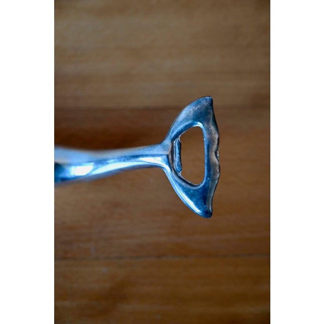 Made in Germany in the 1980s, this chrome "dolphin" bottle opener is an everyday object that perfectly embodies the spirit...