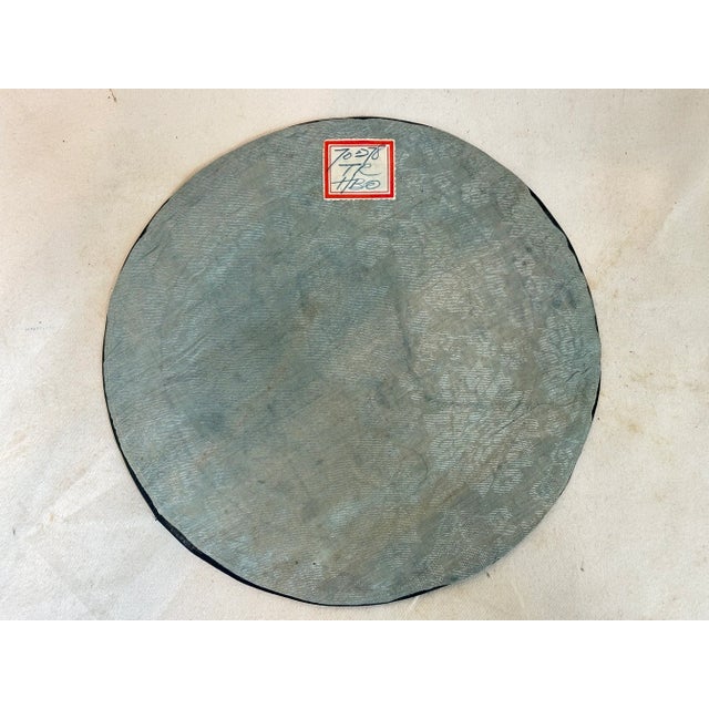 This beautiful round Chinese embroidery depicts a woman in the garden.