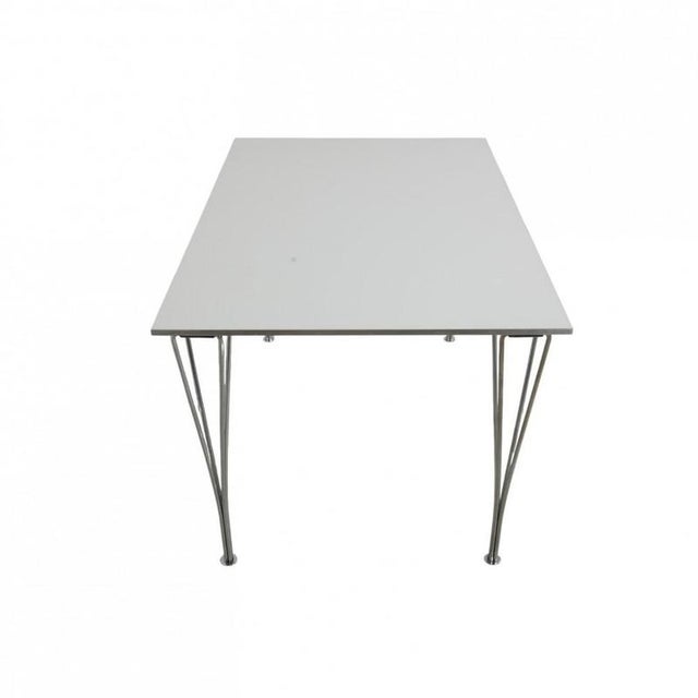 Rectangular Piet Hein dining table with a white laminated tabletop with a steel edge and legs of chrome steel. The table...