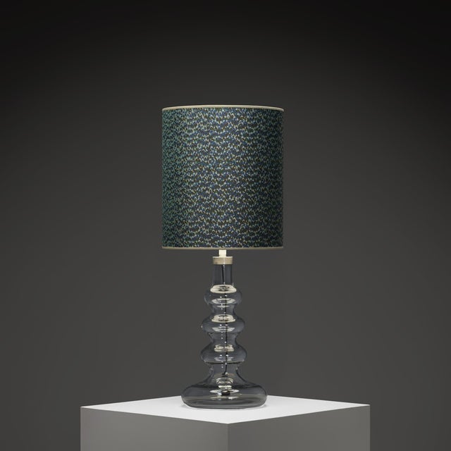 This large glass table lamp by Hsin-Lun Ling for Holmegaard is a striking example of late Scandinavian modern design....
