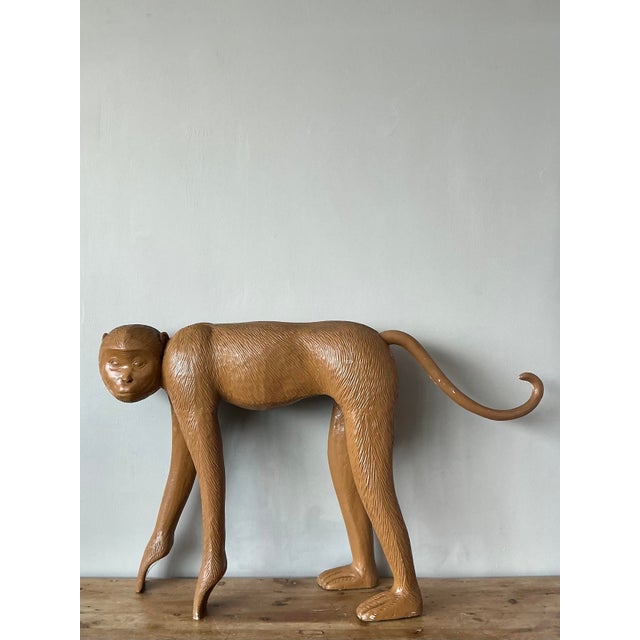 This oversized monkey sculpture is a playful yet sophisticated statement piece, perfectly capturing the whimsical essence...