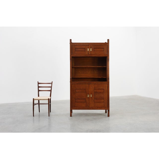 A striking Dutch Jugendstil cabinet in solid quarter‑sawn oak, crafted between 1900 and 1910 and showcasing the refined...