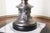 Metal lamp with a delicately decorated leg and a shade with fringes. Fully functional. Switch on the cable and under the...
