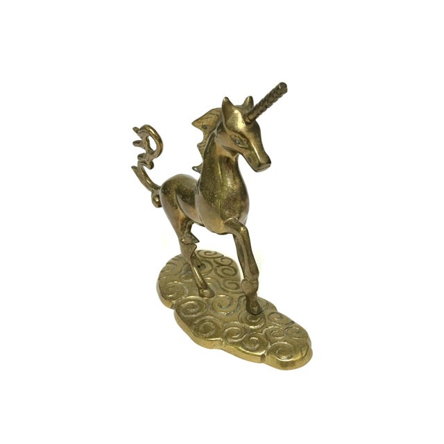 Add a touch of whimsical mystique to your bookshelf or vanity with this solid brass unicorn figurine. Featuring a...