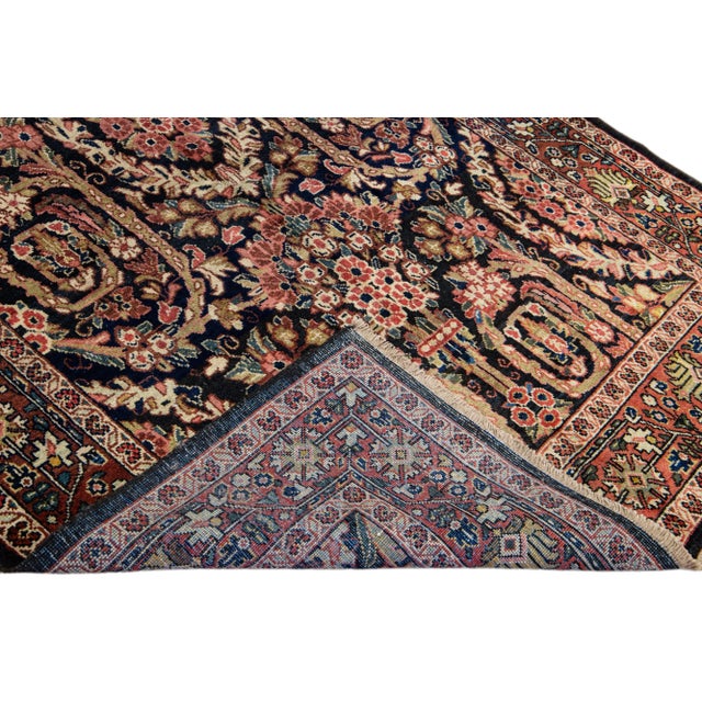 Beautiful Antique Meshakabad hand-knotted wool rug with a dark blue color field. This Persian rug has a designed frame...