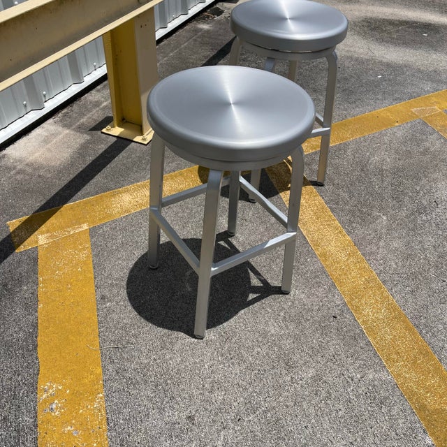 Industrial Style Brushed Aluminum Swivel Bar Stools by Crate & Barrel. A Pair Cushioned seat covers included.