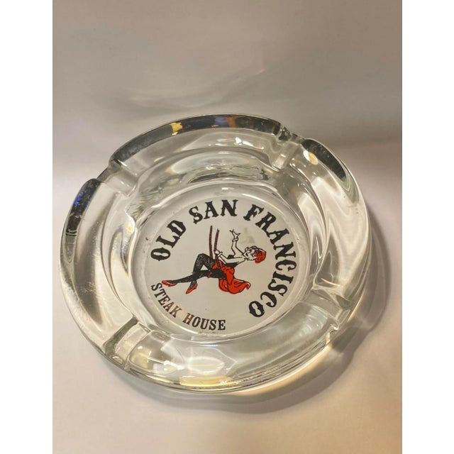 Vintage Glass restaurant ashtray. Thick round glass with four butt rests and decorative center with saloon girl in swing...
