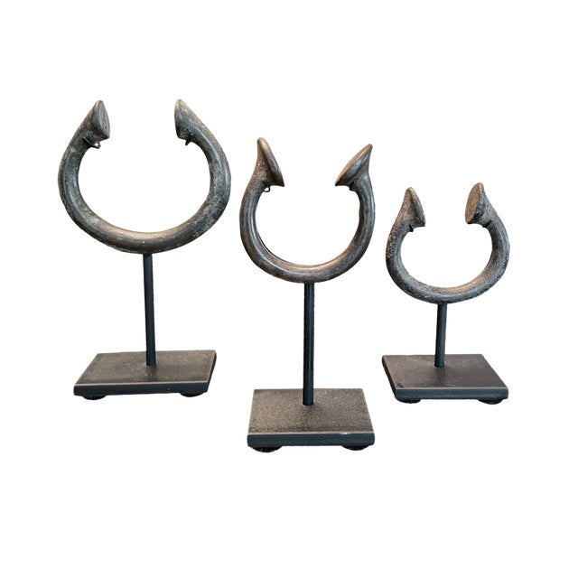 A trio of bronze currency bracelets from West Africa. Introduced by the Portuguese, these pieces soon made their way...