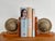 Pair of Italian style wooden bookends with rotating globes featuring antique style maps. The color of the globe pair is...
