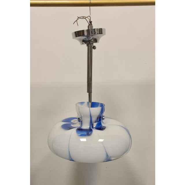 Glass and chromed metal chandelier 80s Delicate chandelier with chromed metal structure and transparent murano glass...