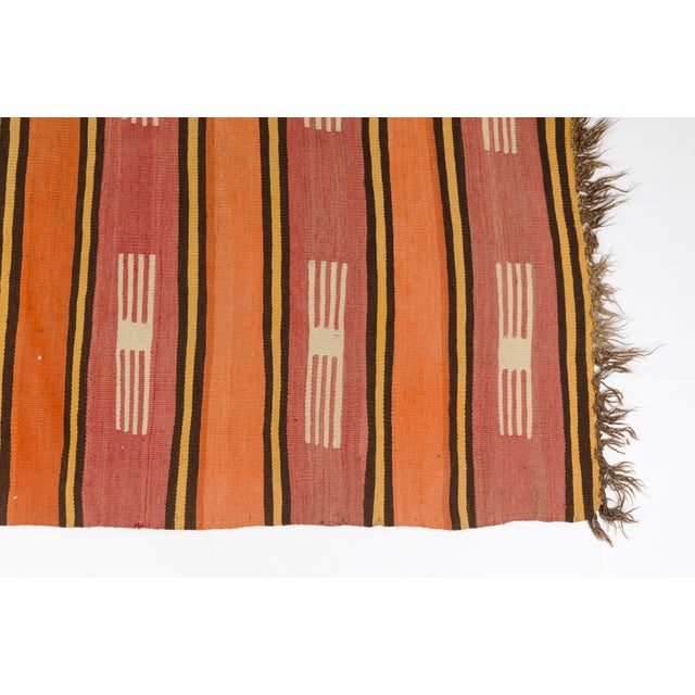 This is a vintage Turkish Oushak rug from the Mid 20th Century. The piece was hand-knotted.