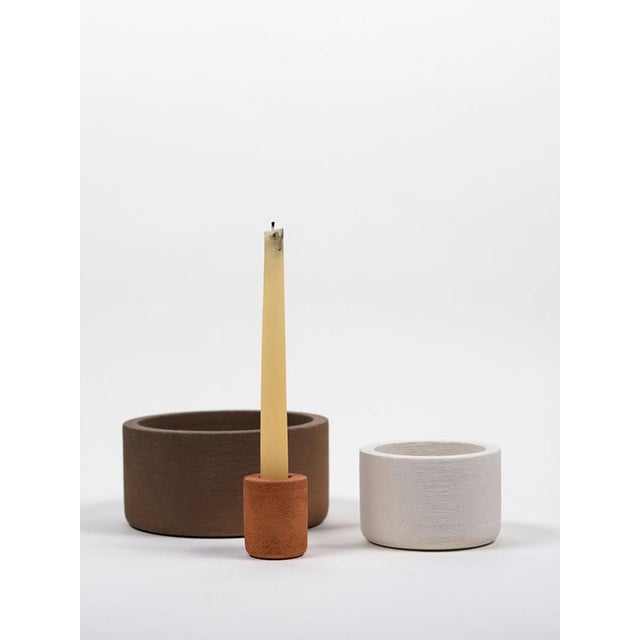 Three natural terracotta elements (made with different clays to create different natural colors), contained and containing...
