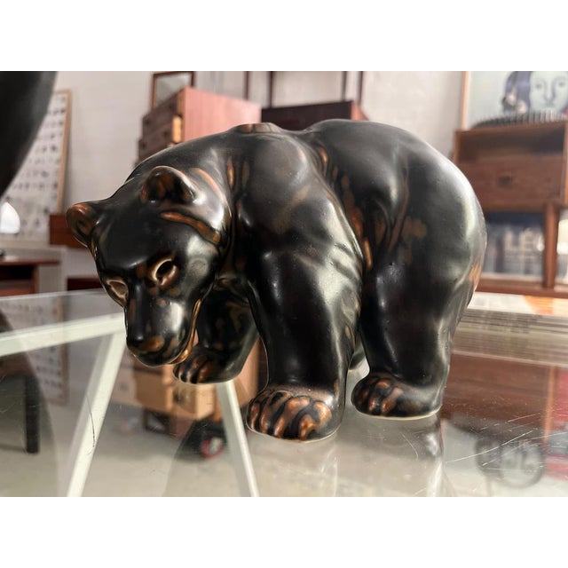 Royal Copenhagen Bear Figurine by Knud Kyhn, Flambé Glaze, 1950s Striking mid-century bear sculpture designed by Knud Kyhn...