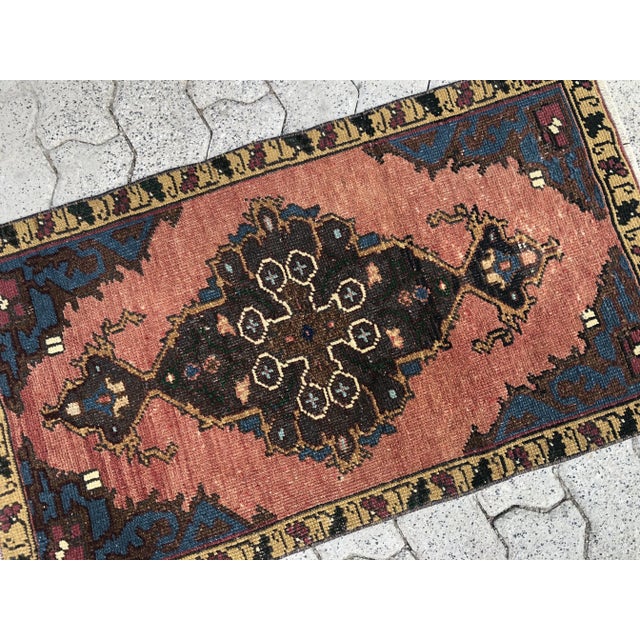 This is a vintage Turkish Oushak rug from the 1960s. The piece was hand-knotted.