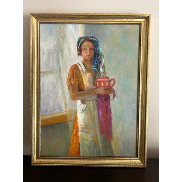 Original oil painting of a young woman holding a teapot. Beautiful, vibrant colors, has a nice warm feeling. Not signed or...