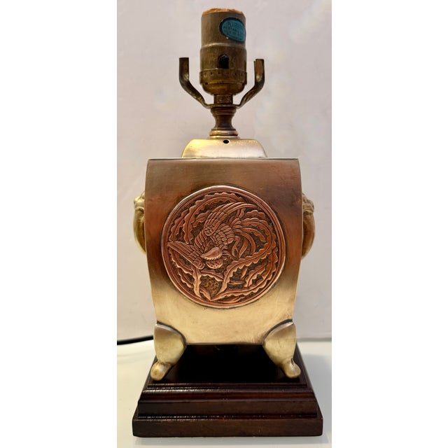 This is a vintage brass Chinese or Chinoiserie-style table lamp by Wildwood Lamps. It features a wooden square base. Lamp...