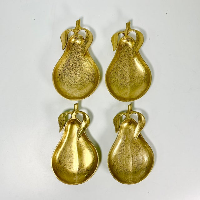 We loved these the moment we found them. It’s a set of four Mid-Century Brass Pear-shaped Dessert Plates. Each features a...