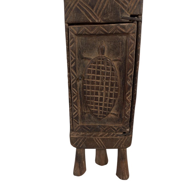 Superb and unique hand-carved wooden box from the Dogon tribe of Mali, featuring a double-door design traditionally used...
