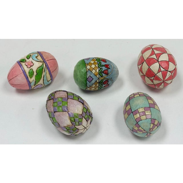 Vintage set of five (5) carved wood colorfully painted Jim Shore eggs. Largest egg measures 2.5"W x 1.5"D x 1.5"H. Four...