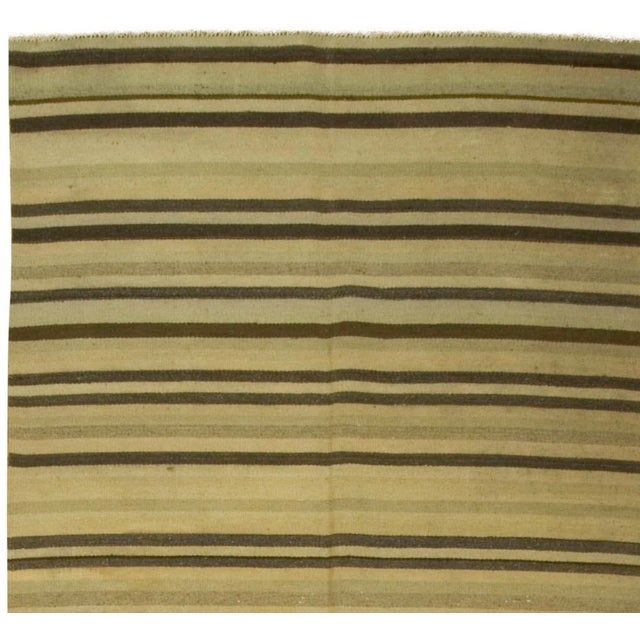 Offered is a vintage Turkish Kilim area rug featuring pale green stripes. Handwoven in the 1940s, this charming piece...