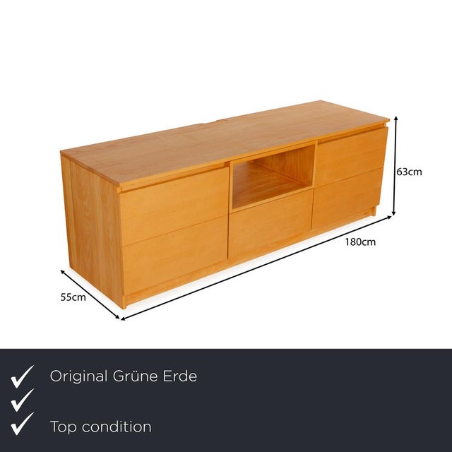 The Grüne Erde sideboard is made of light brown wood and stands floor-to-ceiling. It features a classic, linear design and...