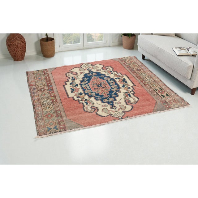 This is a vintage Turkish Oushak rug from the 1960s. The piece was hand-knotted.