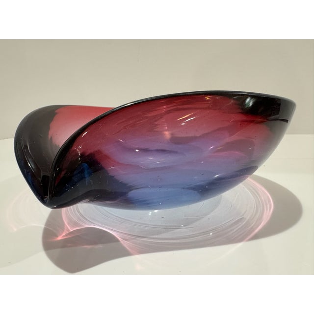 Substantial hand-blown art glass freeform bowl with dramatic folded rim and layered cranberry pink, purple and deep blue...