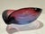 Substantial hand-blown art glass freeform bowl with dramatic folded rim and layered cranberry pink, purple and deep blue...
