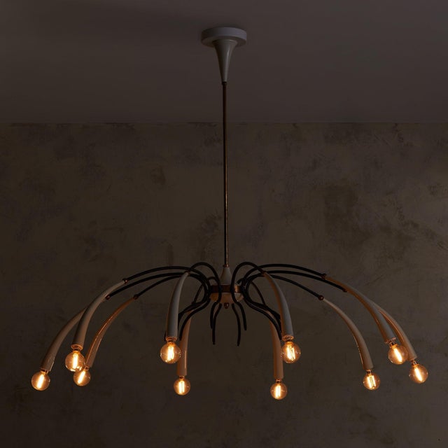 A monumental Italian chandelier from the 1950s, in the manner of Oscar Torlasco, spanning over three feet in diameter. Ten...