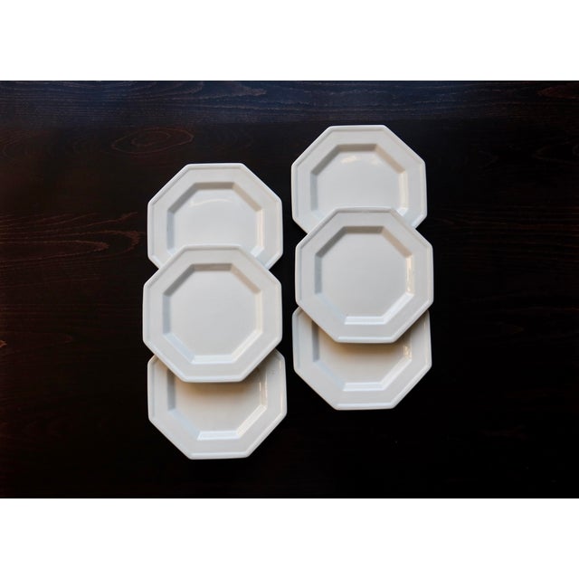 Elegant set of six white earthenware dessert plates by Johnson Brothers. Octagonal shape with a raised, beaded rim; clean...