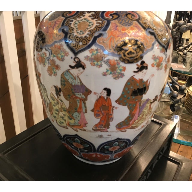 A remarkable hand painted Japanese porcelain Imari vase. Classic iron red and cobalt blue on a white porcelain background....