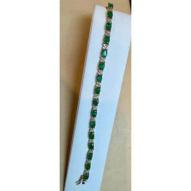 Approximately 12 Carat Emerald 2.2 Carat Diamond Flower Tennis Bracelet 14 Karat Yellow Gold This exceptionally affordable...