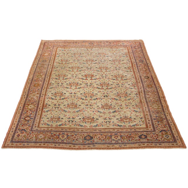 This room-sized rug features a stunning tan-beige foundation, adorned with intricate floral patterns in rust, green, and...