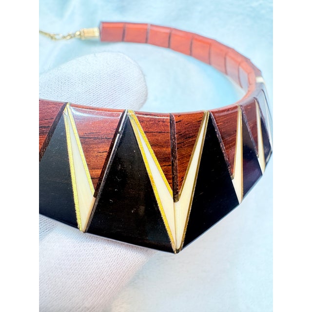 This artisan‑made choker and bracelet set is hand‑crafted from solid rosewood with contrasting ebony and pale hardwood...
