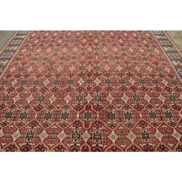 Made with hand-knotted wool and believed to originate from England in the late 19th century, this 11x12 antique Axminster...