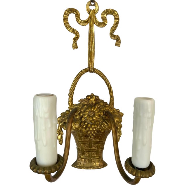 Elegant and classically inspired, this pair of vintage French wall sconces features a sculptural fruit and flower basket...