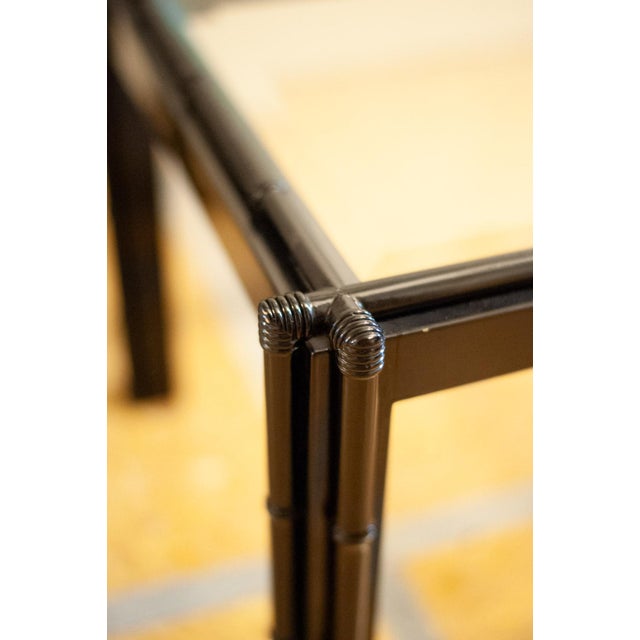 Pair of square low coffee tables with a black-lacquered bamboo-effect wood structure and a recessed beveled glass top....