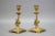 A pair of candle holders made of bronze, France, circa the 1930s. These beautiful bronze candlesticks each feature column...