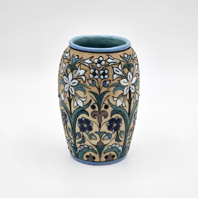 A colorful signed Aguado Toledo Spanish ceramic vase with raised floral relief decoration, blue rim, and multicolor hand-...