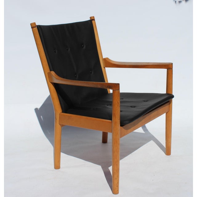 Armchair, model 1788, of beech and cushions in black leather designed by Hans J. Wegner and manufactured by Fritz Hansen...