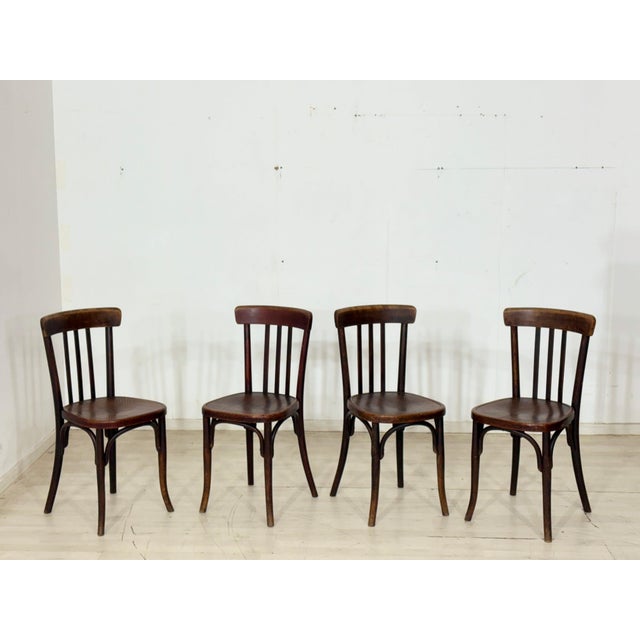 For sale: a set of four beautiful, classic wooden chairs in a timeless bistro or Viennese Workshop style. The chairs...