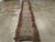 A vintage Tibetan rug in runner format handmade during the mid-20th century. Measures: 2' 6" x 16' 1".