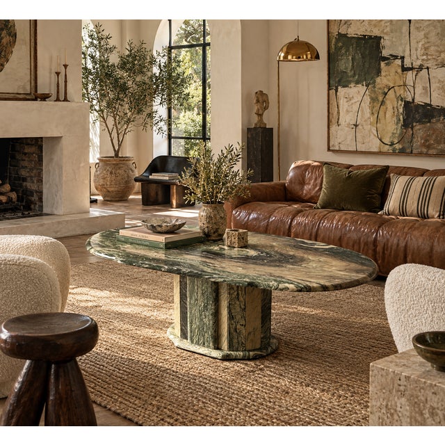 Carved from a dramatic slab of green Cipollino Ondulato marble, this oval coffee table is defined by sweeping bands of...