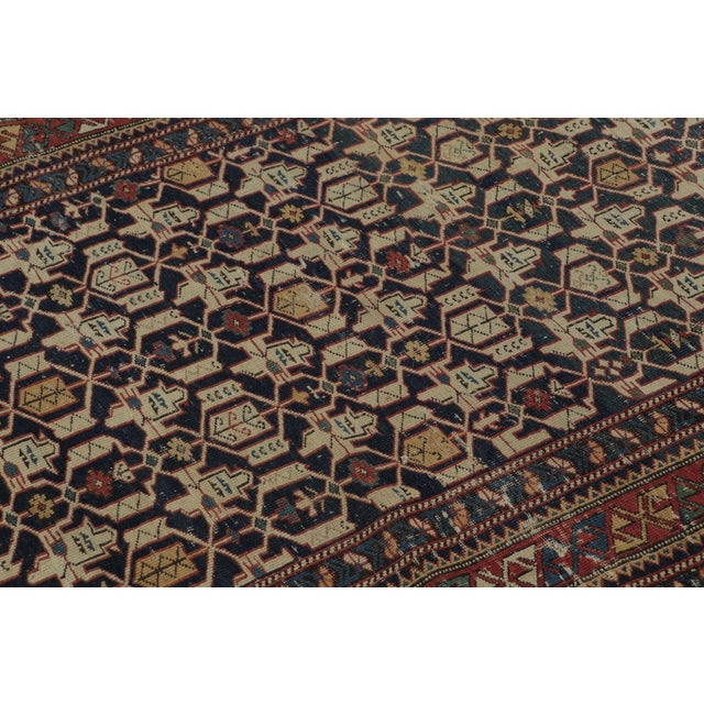Hand-knotted in wool, this 4x5 Vintage Turkish Anatolian rug, circa 1950–1959, features an intricate geometric lattice of...