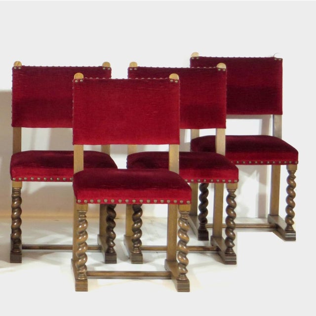 Set of eight sturdy 19th century castle dining chairs with stylish barley twist oak frame and red velvet upholstery. The...