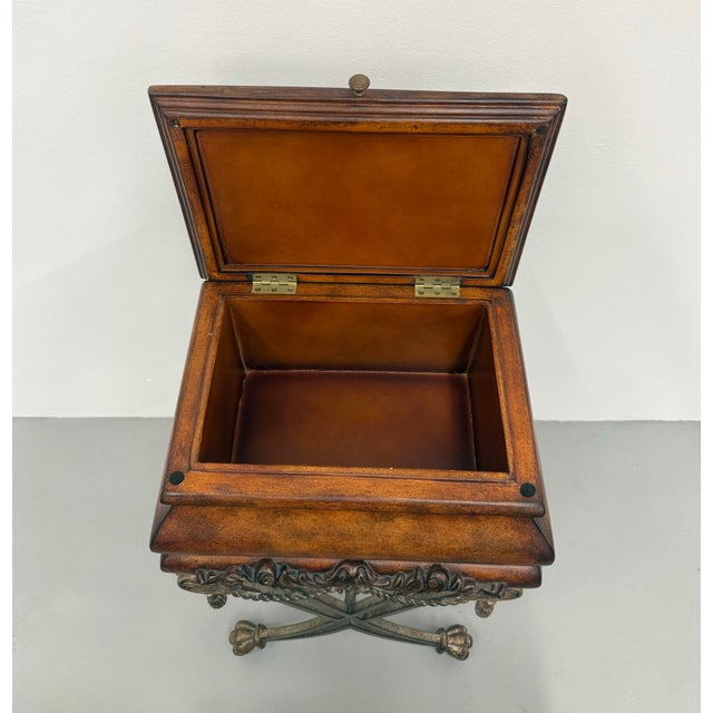 An ornate decorative sewing or storage box featuring a warm wood case with a hinged leather-lined lid and carved foliate...